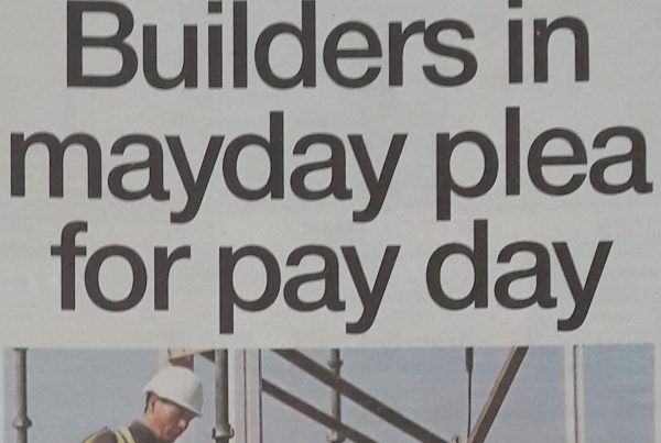 Headline banner featuring “Builders in mayday plea for pay day” overlaid on an image of a construction site with machinery halted, highlighting financial struggles during the COVID-19 crisis.