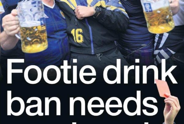 Banner image of a football stadium crowd with plastic cups raised in the air. Bold overlay text reads: “Footie drink ban needs a red card.”