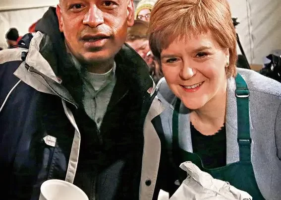 Nicola Sturgeon serving breakfast to Shaf Rasul after the Social Bite Sleepout in Edinburgh