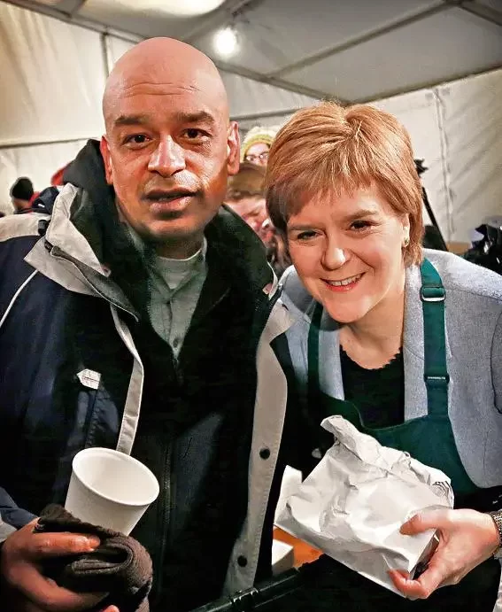Nicola Sturgeon serving breakfast to Shaf Rasul after the Social Bite Sleepout in Edinburgh