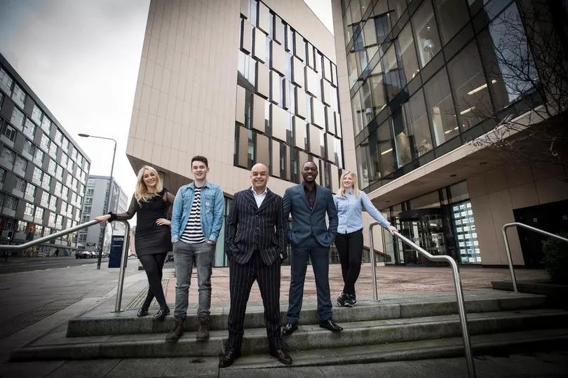 Shaf Rasul standing outside the University of Strathclyde with entrepreneurs from the university