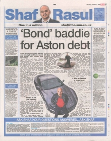 A newspaper column layout featuring the headline “Bond Baddie for Aston Martin Debt,” with sections on Aston Martin’s financial challenges, support for Scottish entrepreneurs, the discovery of an illicit distillery, and Ted Baker’s recent losses.