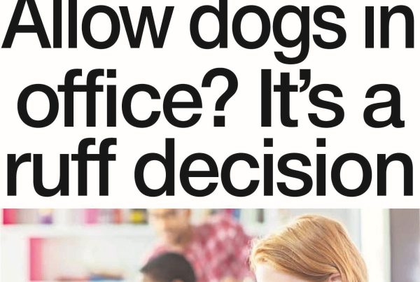 Office desk with a relaxed dog under it, employees smiling in the background, captioned with the headline “Allow Dogs in Office? It's a Ruff Decision”