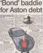 A headline reading "Bond Baddie for Aston Martin Debt" overlaying an image of a luxury Aston Martin DBX alongside a James Bond film still, symbolising the tension between glamour and financial risk.
