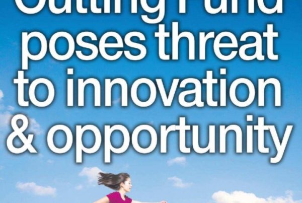 Graphic banner featuring an empty classroom or training space symbolising workforce development, with overlay text: “Cutting Fund poses threat to innovation & opportunity”. Visual elements suggest tension between progress and policy cuts.