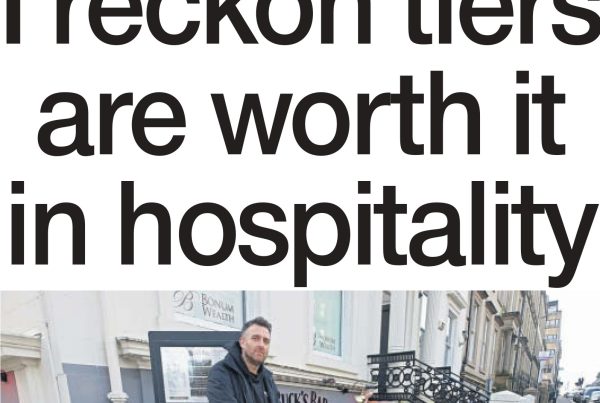 A headline reading "I reckon tiers are worth it in hospitality" overlaid on an image of a closed pub with tier level posters in the window and empty chairs stacked inside.
