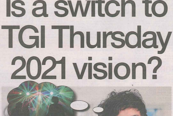 A cheerful desk calendar flipped to “Thursday,” with festive lights and a laptop showing “2021 goals” in the background. Headline reads “Is a switch to TGI Thursday 2021 vision?”