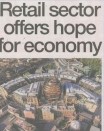 A headline reading "Retail sector offers hope for economy" overlaying an image of a bustling high street with new shops opening and customers carrying shopping bags, reflecting cautious optimism in the retail sector.
