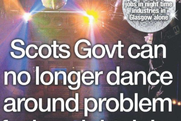 A dimly lit dancefloor in a Scottish nightclub with colourful strobe lighting, empty bar stools, and a closed sign suggesting economic uncertainty.