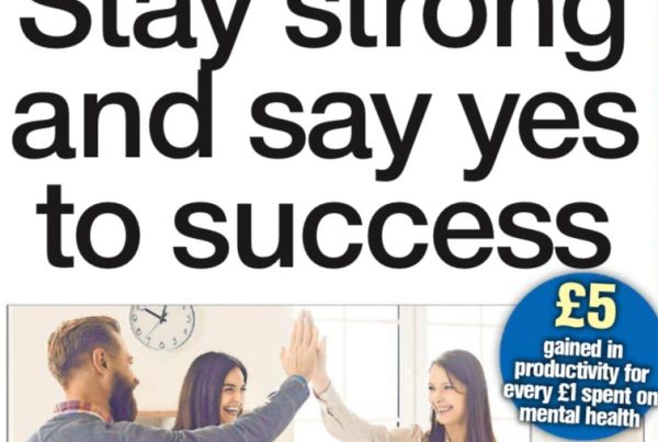 Banner showing the headline “Stay strong and say yes to success” over a backdrop of determined business professionals walking in silhouette against a city skyline at dawn.