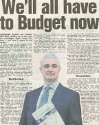 A banner image featuring the headline “WE'LL ALL HAVE TO BUDGET NOW” with a background showing worried people reviewing bills, tax symbols, and Scottish landscapes.