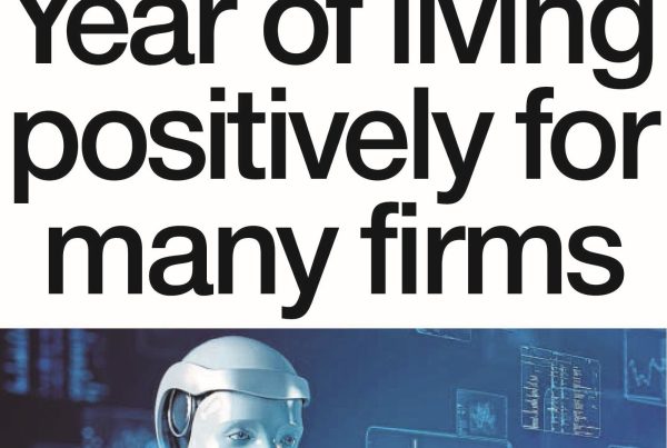 Illustration of business people moving between office and home desks, with wind turbines and digital devices in the background. Text reads “Year of Living Positively for Many Firms”.